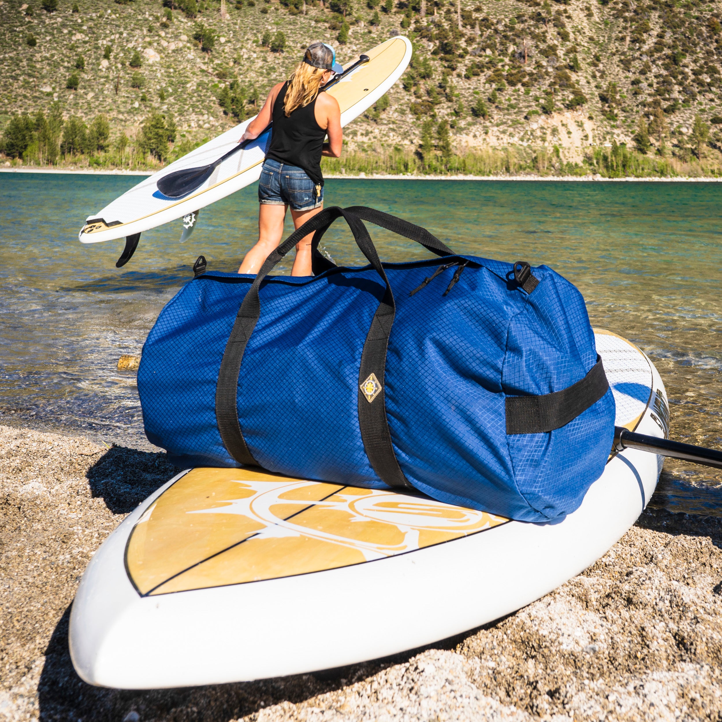 Duffel bag on a paddle board at a mountain lake. Northstar Bags make great adventure duffles. The SD1640 can carry an inflatable stand up paddle board, life vests, oars, towels, and a change of clothes. Northstar sport duffles carry the fun!