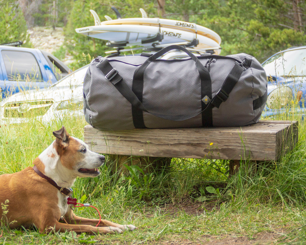 Image showing a Northstar Bags SD1430 standard duffle bag on a bench with a cute dog named Harley. Northstar duffel bags get your gear where you're going. Duffel bags built for life. Buy it for life with Northstar's lifetime guarantee.